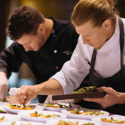 Chefs plating a meal